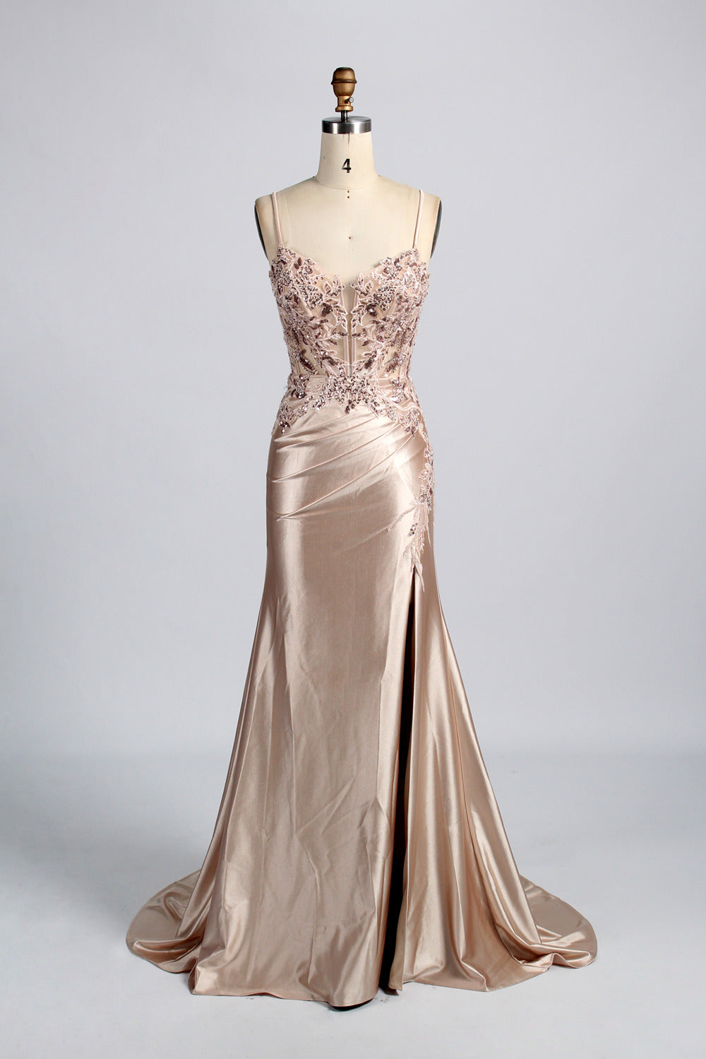 photograph of a beautiful woman wearing a stunning royal blue evening gown with a thigh-high slit, intricate lace detailing on the bodice, elegant design, long sleeves, slim fit, standing in a studio with soft lighting, white background, delicate jewelry, dark hair styled in a sleek updo, confident pose, graceful, sophisticated, fashion photography, high-quality, luxurious, formal attire, glamorous.33028-08