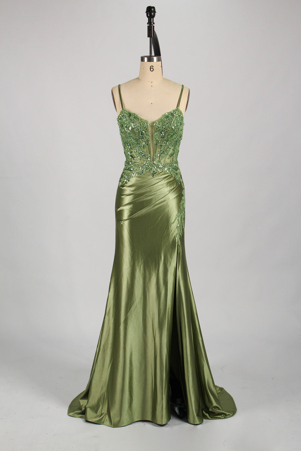photograph of a beautiful woman wearing a stunning royal blue evening gown with a thigh-high slit, intricate lace detailing on the bodice, elegant design, long sleeves, slim fit, standing in a studio with soft lighting, white background, delicate jewelry, dark hair styled in a sleek updo, confident pose, graceful, sophisticated, fashion photography, high-quality, luxurious, formal attire, glamorous.33028-09