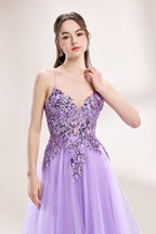 photograph of a young woman wearing a beautiful, floor-length, lavender ball gown with intricate sequin detailing on the bodice, sheer tulle skirt, spaghetti straps, long brown hair, fair skin, standing in a soft lit studio, neutral background, elegant, sophisticated, dreamy, fashion, glamour, full body shot, high quality, fashion photography, stylish, feminine, graceful, classy, modern, delicate, light, airy.33040-03
