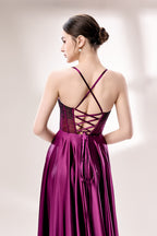 photograph, elegant woman, standing, studio lighting, white background, full-length shot, wearing a floor-length, deep purple satin gown, lace details, spaghetti straps, high slit on one side, hands on hips, brown hair in a sleek updo, red lipstick, soft shadows, minimalistic setting, fashion photography, evening wear, classy, sophisticated, stylish, modern, feminine, confident pose, high-quality image, no visible watermark.33116B-06