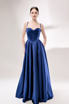 photo of a beautiful young woman, Asian descent, fair skin, long black hair in a low bun, wearing a stunning royal blue satin gown, corset-style top, full skirt, elegant and classy, standing against a plain white background, soft lighting, minimalistic setting, hands behind her back, confident pose, fashion photography, high-quality image, no watermarks.33119-01