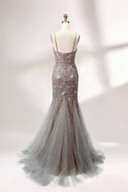 Showcased on a mannequin is a taupe - toned mermaid - cut gown. It has thin straps, a sweetheart neckline, and is embellished with delicate silver floral embroidery all over, plus a flowing tulle skirt. The refined design gives off a glamorous aura, ideal for formal events such as proms or weddings.2