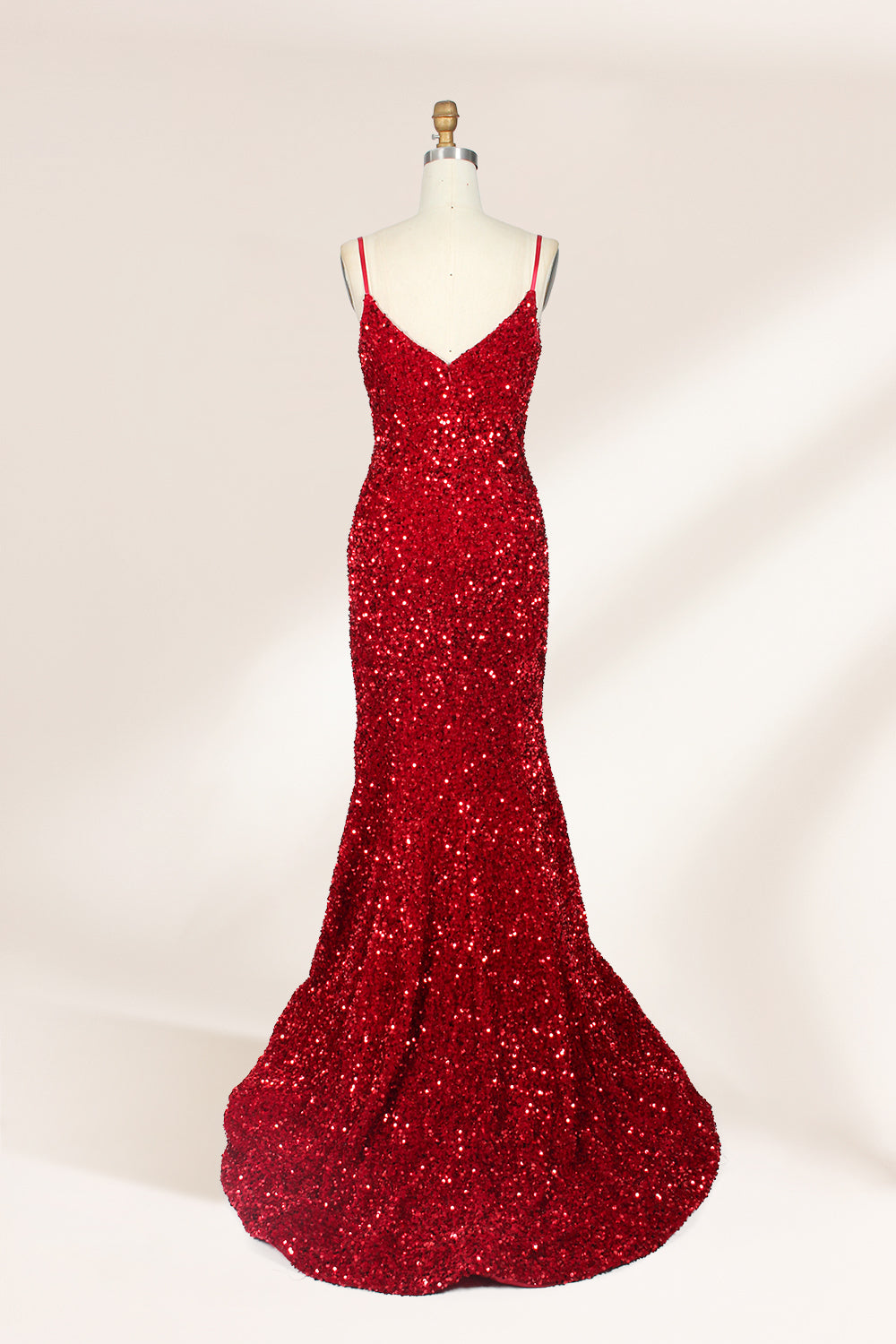 photograph of a mannequin wearing a red sequin evening gown, full-length, floor-length, sleeveless, V-neck, fitted bodice, flared skirt, glossy texture, elegant, glamorous, fashion, studio lighting, white background, soft shadows, high-end fashion, no accessories, no jewelry, no shoes, no face, no hair, no makeup, no background details, simple composition, focus on dress, no people, no textures, no patterns, no objects.02