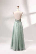A mannequin showcases a light - green tulle gown with a lace - embroidered, sheer bodice. It has thin straps, a deep V - neckline, and a voluminous skirt. The delicate lace and flowing tulle create a romantic look, perfect for formal events like weddings or proms, exuding elegance.
2