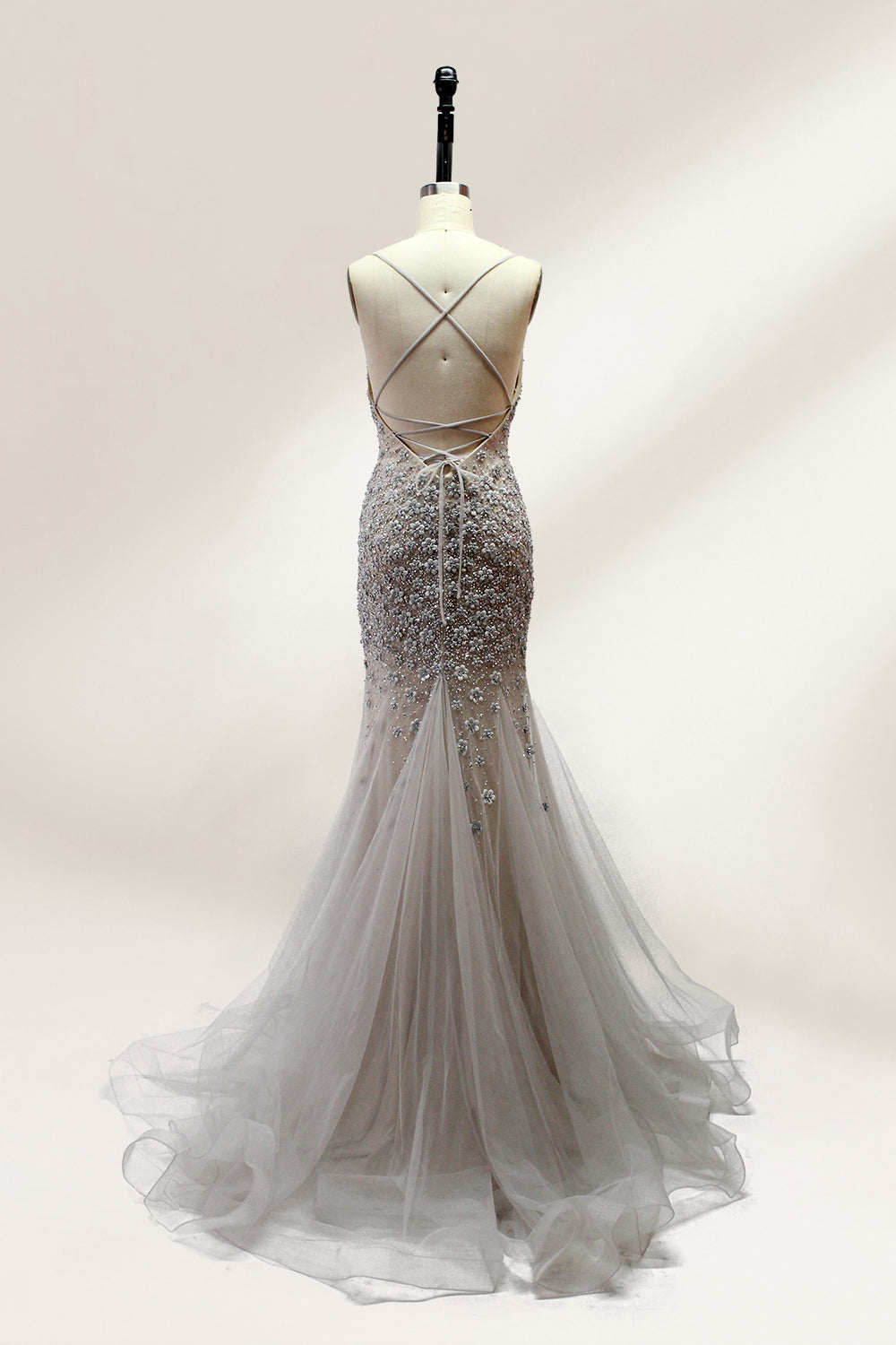 Displayed on a mannequin is a silver - gray mermaid - style gown. It features thin straps, a sweetheart neckline, intricate bead and sequin embroidery throughout, and a flowing tulle skirt. The elegant design creates a glamorous look, perfect for formal events like proms or weddings.2