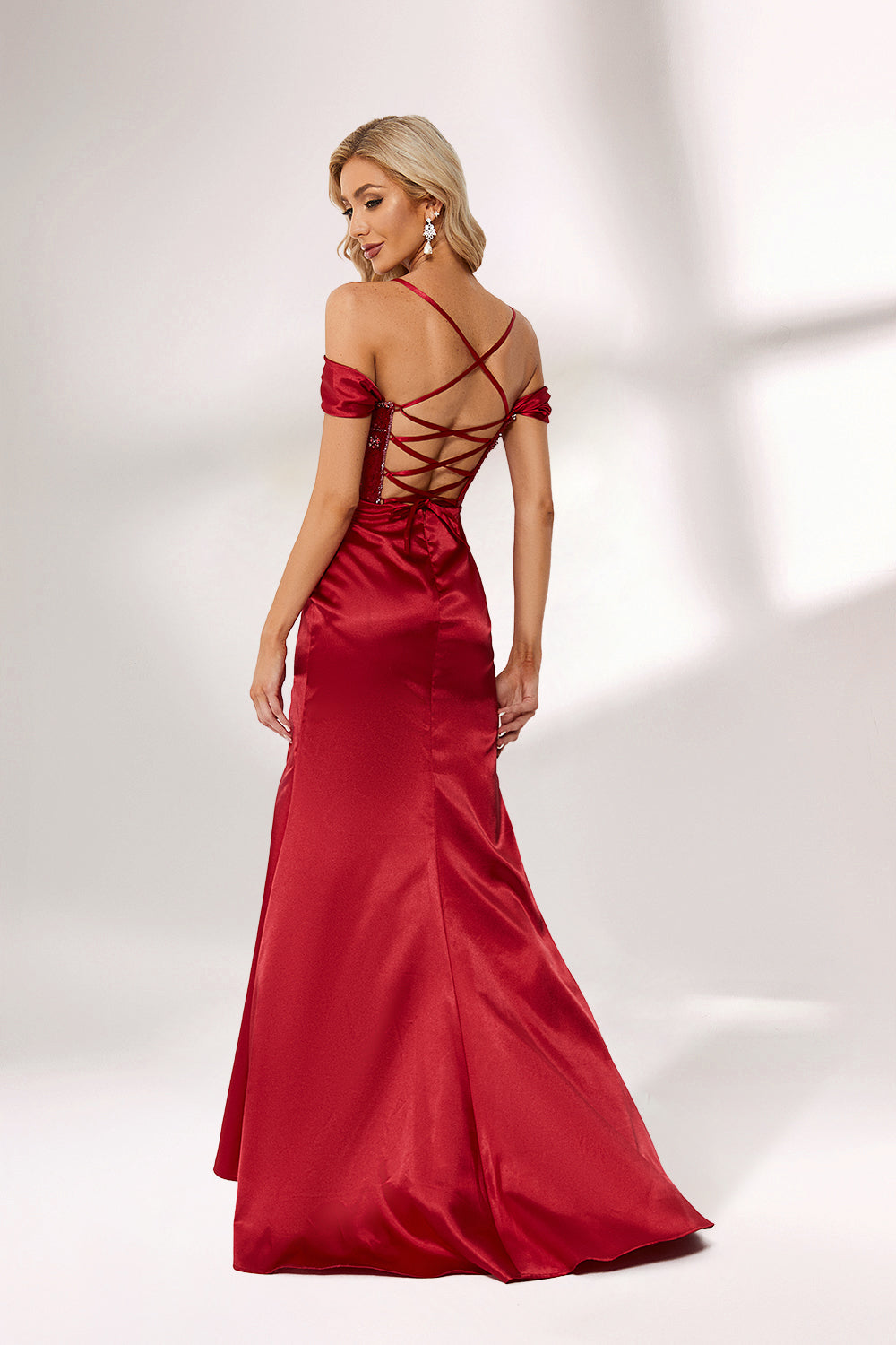 A woman stands against a light background, wearing a deep - red satin gown. It features off - shoulder sleeves, a beaded bodice, and a high side slit. The intricate bead patterns and ruched skirt create a glamorous look, perfect for formal events like galas or evening parties, exuding elegance and charm.2