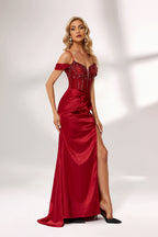 A woman stands against a light background, wearing a deep - red satin gown. It features off - shoulder sleeves, a beaded bodice, and a high side slit. The intricate bead patterns and ruched skirt create a glamorous look, perfect for formal events like galas or evening parties, exuding elegance and charm.4