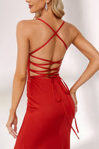 Bathed in soft light, a woman radiates charm in a red evening gown. With spaghetti straps, a deep V - neck, and a thigh - high slit, it crafts an elegant yet alluring look for formal events.4
