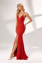 Bathed in soft light, a woman radiates charm in a red evening gown. With spaghetti straps, a deep V - neck, and a thigh - high slit, it crafts an elegant yet alluring look for formal events.1