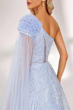 In soft lighting, a woman stuns in a light blue one - shoulder evening gown. It has a floral accent on the shoulder, a sheer cape - like detail, and intricate silver embroidery. The dreamy design creates an elegant and fairy - tale - like look, perfect for grand events.6