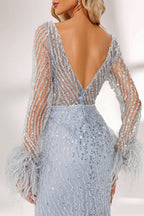 Set against a light backdrop, a woman dons a light - blue sequin gown with sheer sleeves and feather cuffs. It has a V - neckline, a mermaid - shaped skirt, and shimmering sequins. The unique feather details and sparkling fabric create a glamorous look, ideal for proms or formal evening events.6