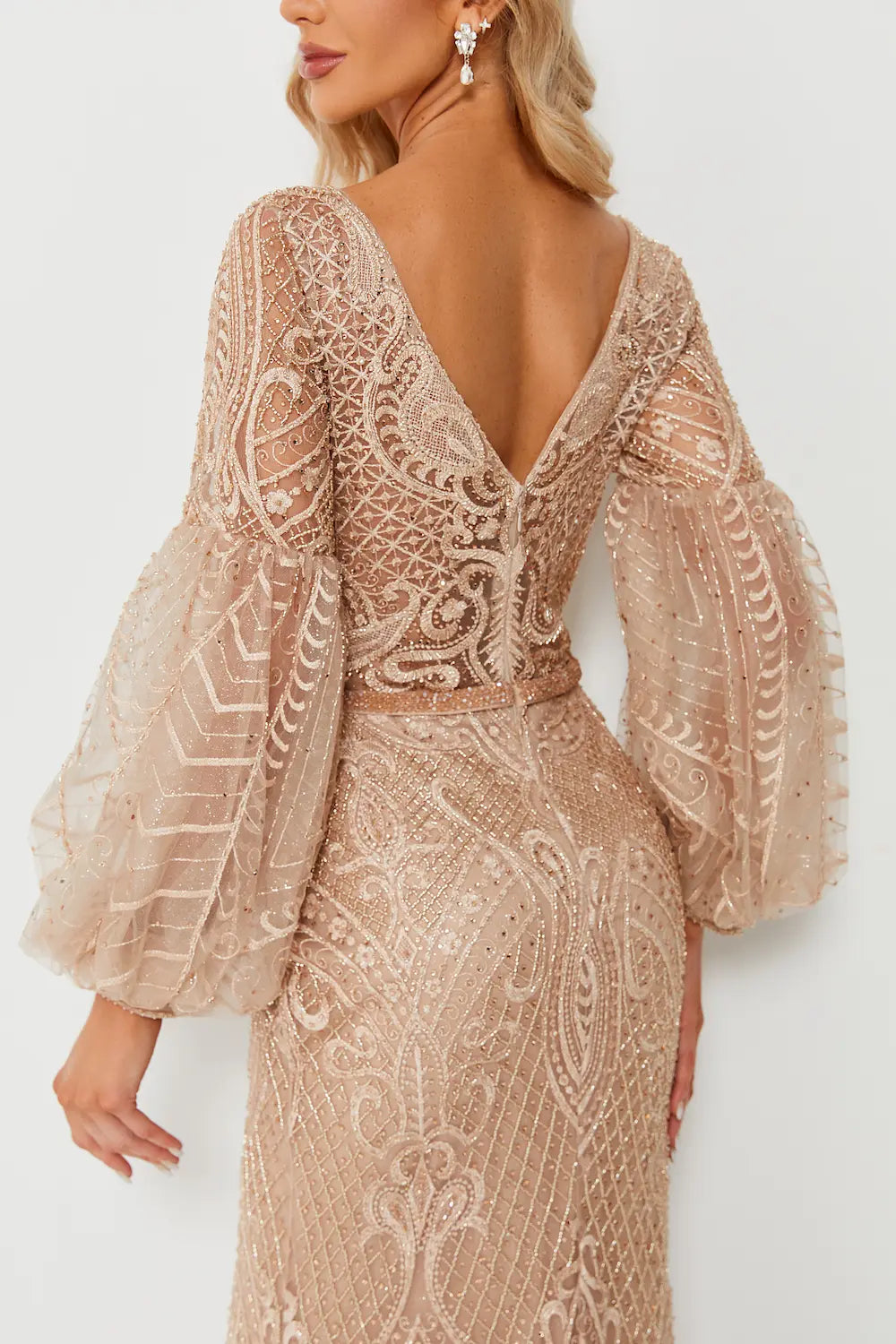 Champagne beaded V-neck gown with geometric textured pattern and long sheer puff sleeves