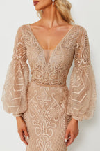 Champagne beaded gown with open V back, sheer puff sleeves, and lace-like applique