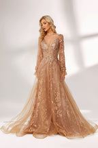 Set against a light backdrop, a woman is clad in a champagne - hued tulle gown. It boasts a deep V - neckline, long sheer sleeves adorned with lace embroidery, and a flowing tulle skirt featuring gold floral accents. The refined design exudes a romantic and luxurious charm, ideal for formal occasions such as proms or weddings.3