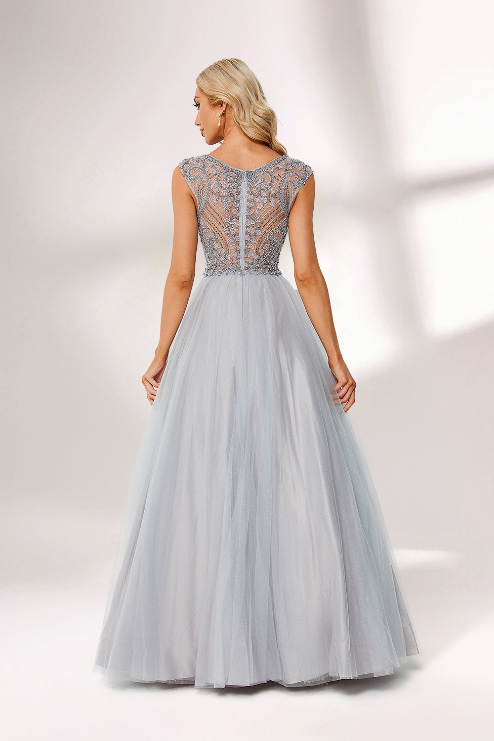 Silver gray tulle prom dress with beaded bodice, illusion back & cap sleeves. V-neck ball gown design adds elegance. Great for formal events & bulk buys.02