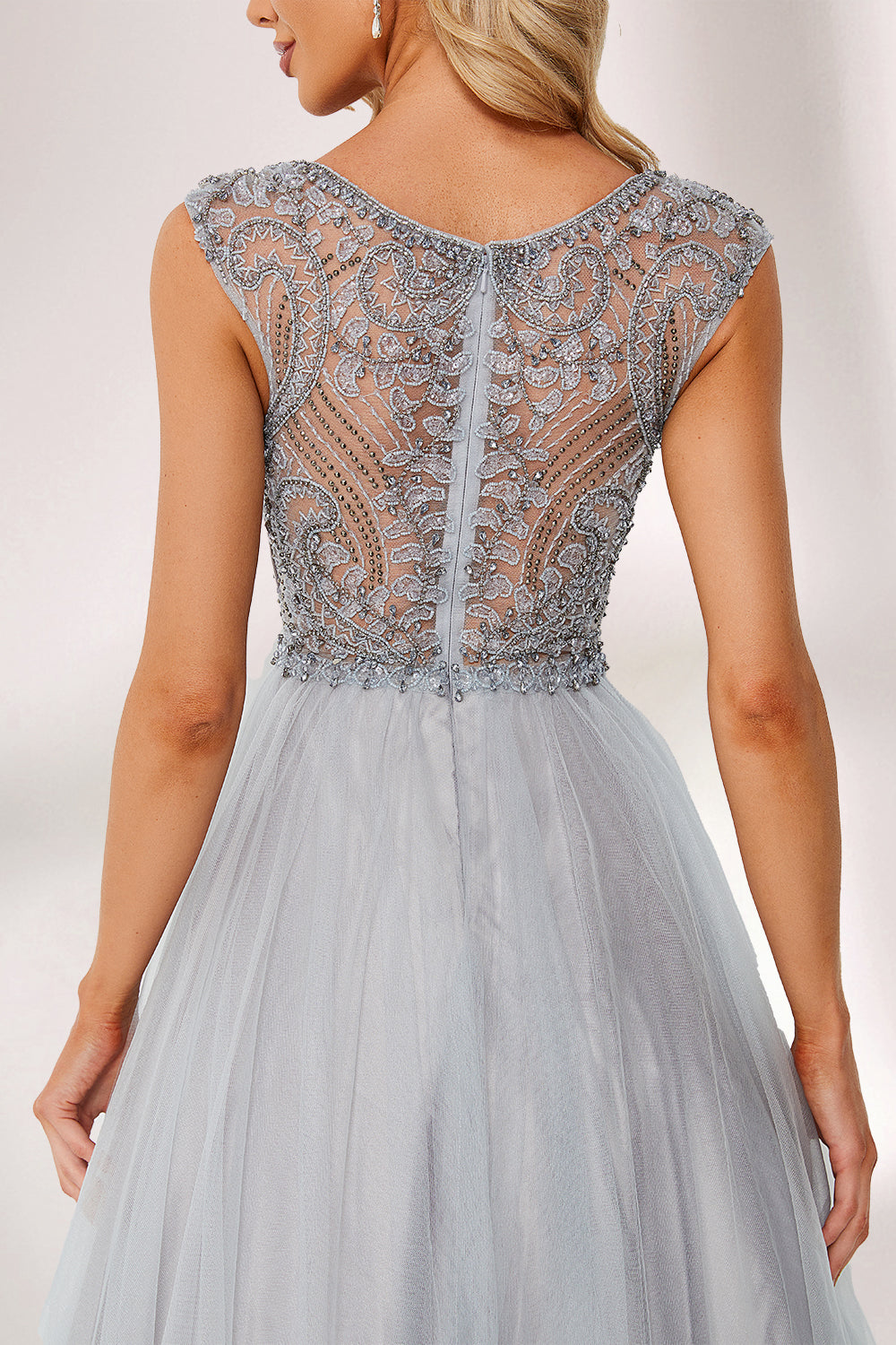 Silver gray tulle prom dress with beaded bodice, illusion back & cap sleeves. V-neck ball gown design adds elegance. Great for formal events & bulk buys.03