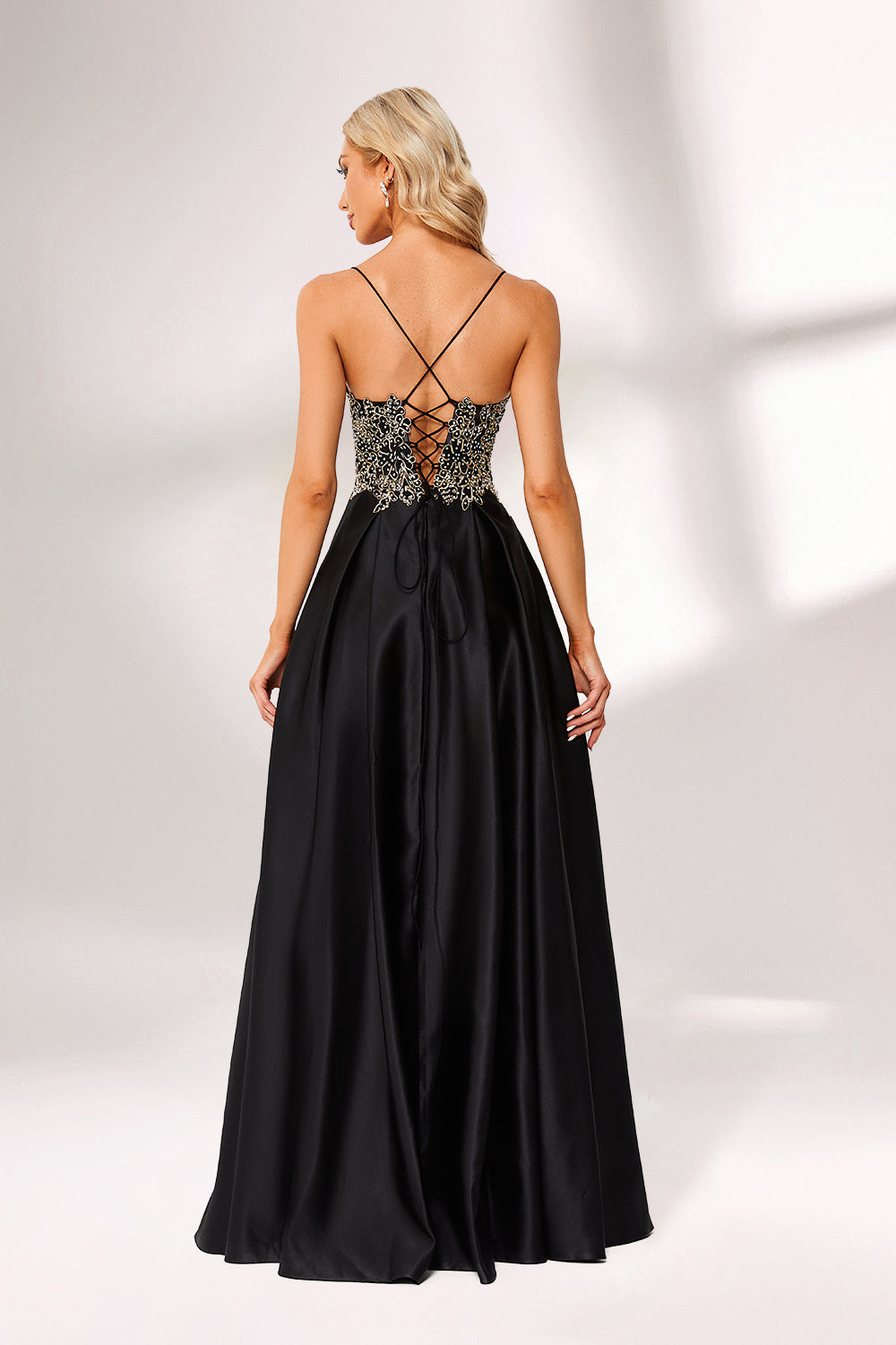 A woman stands against a light background, wearing a black satin gown. The bodice features intricate silver bead embroidery, a deep V - neckline, and thin straps. The voluminous skirt adds elegance, perfect for formal events like galas or weddings, exuding sophistication.3