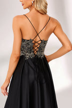 A woman stands against a light background, wearing a black satin gown. The bodice features intricate silver bead embroidery, a deep V - neckline, and thin straps. The voluminous skirt adds elegance, perfect for formal events like galas or weddings, exuding sophistication.2