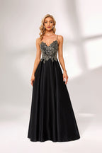 A woman stands against a light background, wearing a black satin gown. The bodice features intricate silver bead embroidery, a deep V - neckline, and thin straps. The voluminous skirt adds elegance, perfect for formal events like galas or weddings, exuding sophistication.4