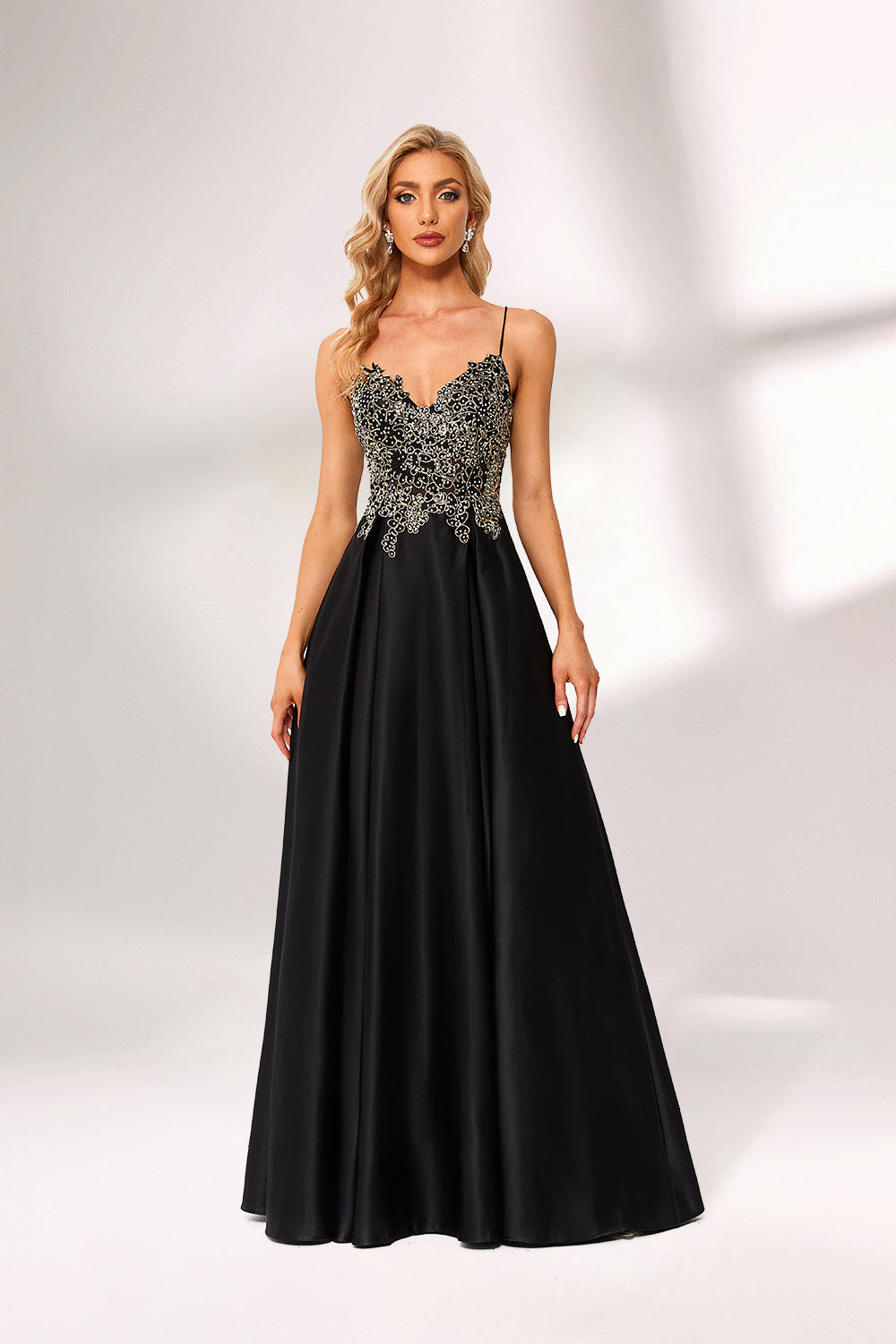 A woman stands against a light background, wearing a black satin gown. The bodice features intricate silver bead embroidery, a deep V - neckline, and thin straps. The voluminous skirt adds elegance, perfect for formal events like galas or weddings, exuding sophistication.4