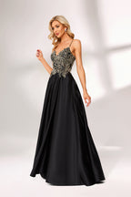 A woman stands against a light background, wearing a black satin gown. The bodice features intricate silver bead embroidery, a deep V - neckline, and thin straps. The voluminous skirt adds elegance, perfect for formal events like galas or weddings, exuding sophistication.5