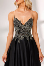 A woman stands against a light background, wearing a black satin gown. The bodice features intricate silver bead embroidery, a deep V - neckline, and thin straps. The voluminous skirt adds elegance, perfect for formal events like galas or weddings, exuding sophistication.6