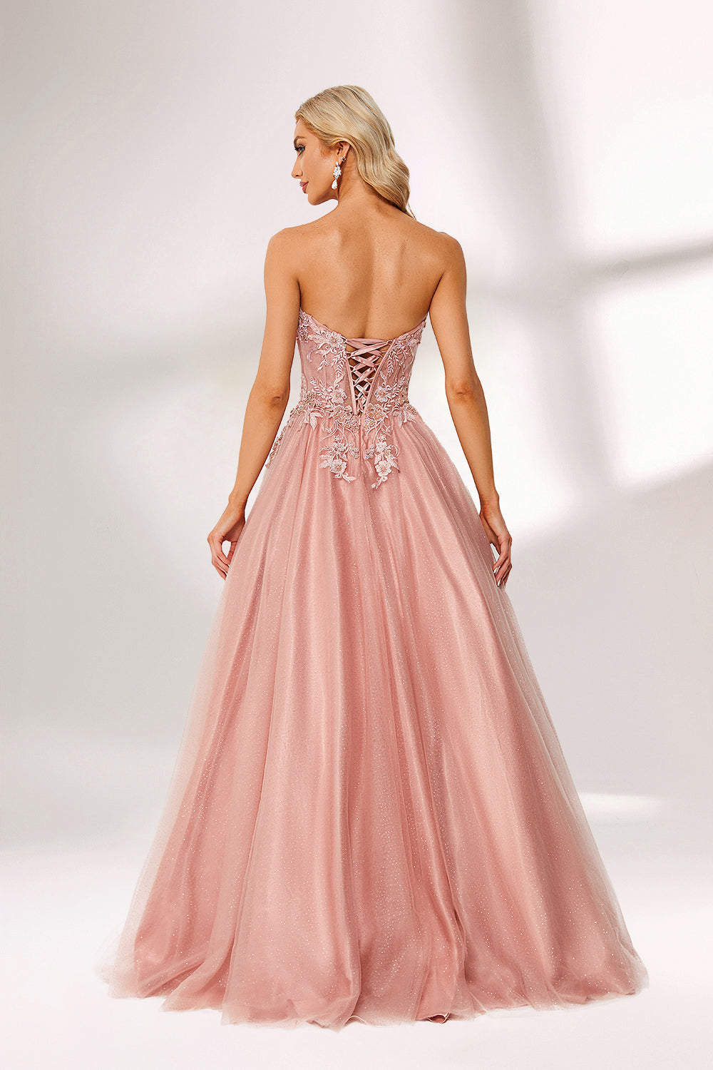 Blush pink tulle prom dress with strapless lace bodice, corset back, floral embroidery, and ball gown silhouette—ideal for bulk elegant formal collections.02