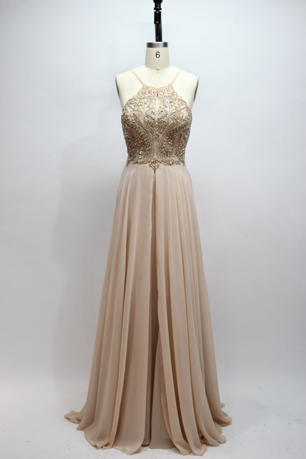 Photograph of a navy blue, floor-length, sleeveless gown on a dress form. The dress features intricate beadwork and sequin embellishments on the bodice, with a flowing, sheer skirt. The form is placed against a plain, light beige background, highlighting the dress's elegant, sophisticated design.9107-07