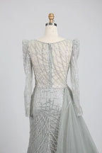 Silver long-sleeve mermaid gown with wide off-shoulder sleeves and draped back detail