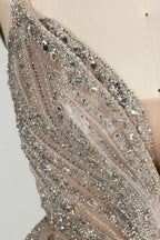 Close-up of champagne tulle with dense silver beaded embellishment and sequined lines