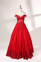 Photograph of an elegant, off-the-shoulder red ball gown on a white dress form. The dress features intricate, sparkling beadwork on the bodice and a voluminous, flowing skirt adorned with delicate floral patterns. The background is a plain white studio setup with soft shadows, emphasizing the dress's vibrant color and luxurious texture.01