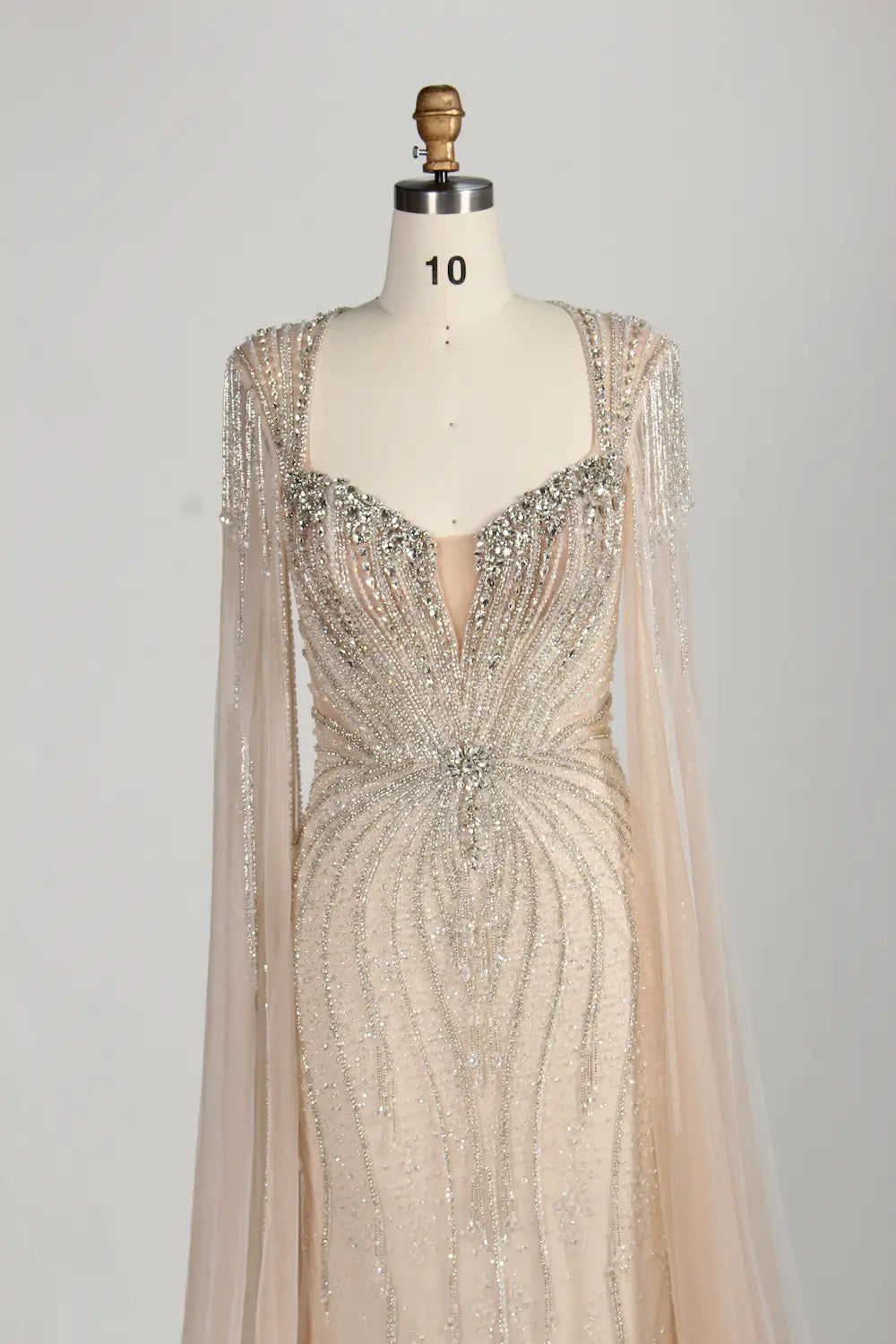 Silver-champagne beaded sweetheart mermaid gown with sheer cape sleeves