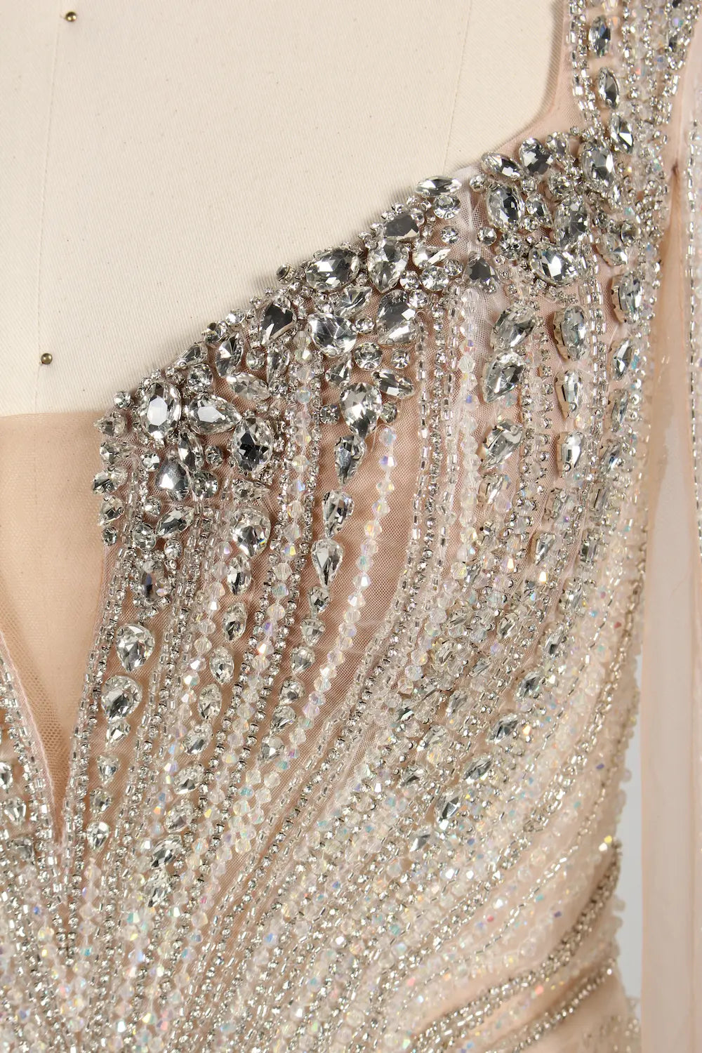 Close-up of silver-toned beadwork on sheer tulle for an embellished bodice
