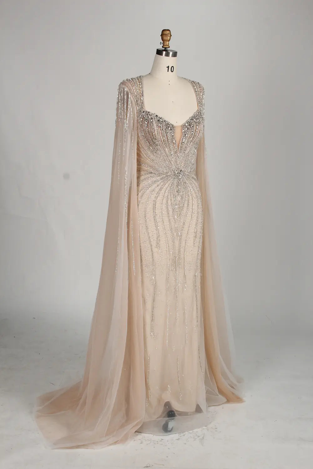 Beaded tulle mermaid gown with V-front sweetheart neckline and flowing sheer cape