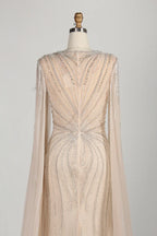 Beaded tulle mermaid gown with open back and long sheer cape sleeves
