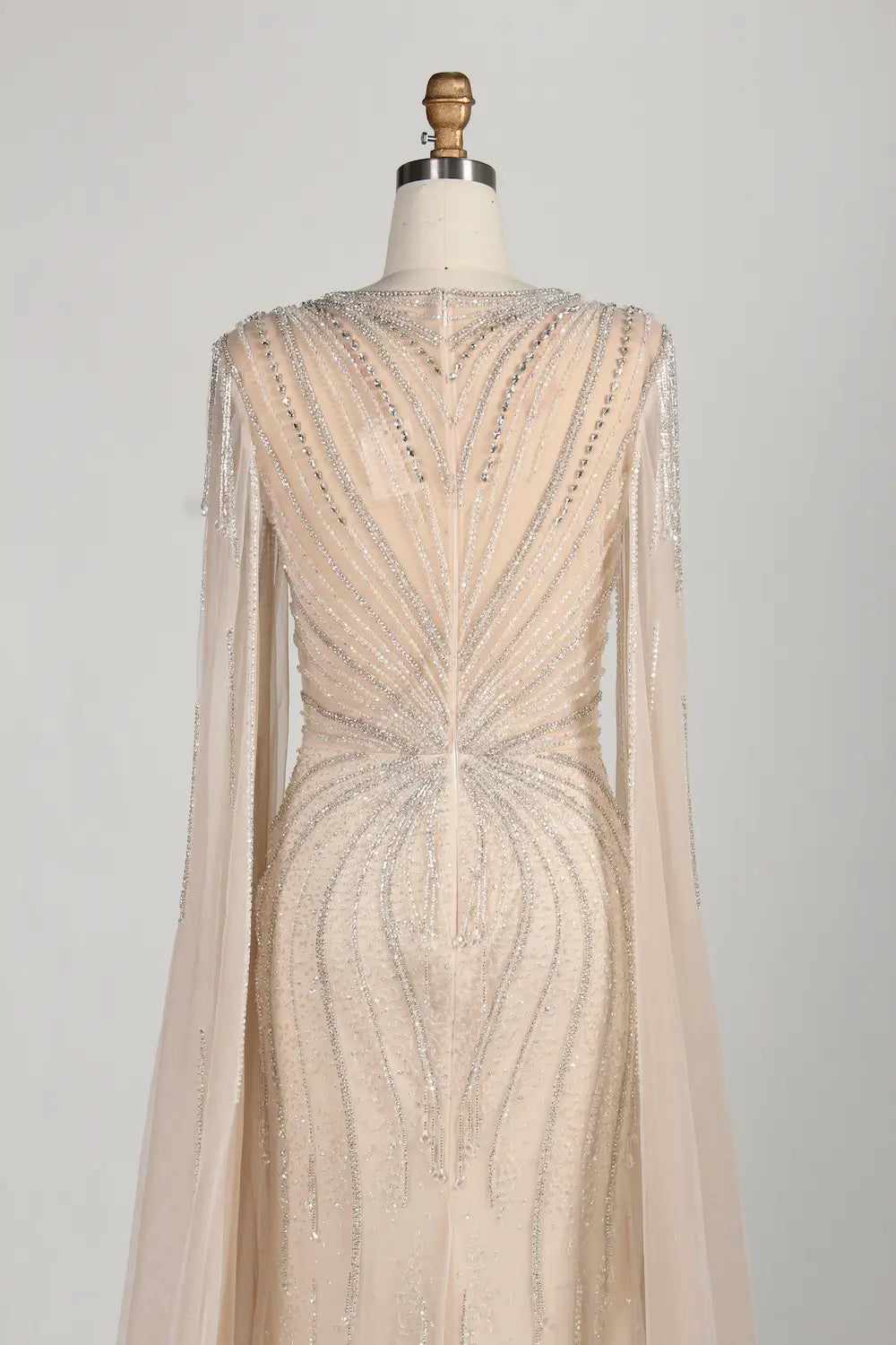 Beaded tulle mermaid gown with open back and long sheer cape sleeves