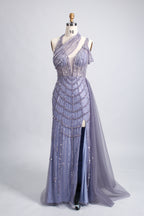 A woman with an elegant updo and a poised stance wears a teal, beaded gown. It has a high - neck, cut - out shoulder design, a form - fitting bodice, and a high side slit. A flowing tulle train adds drama. Paired with silver heels, it's perfect for formal events like galas, radiating glamour.8