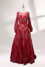 Presented on a mannequin is a deep - red evening gown. It features a sheer neckline, long billowy sleeves, and intricate gold - toned embroidery throughout. The elaborate design gives off a luxurious and elegant vibe, ideal for formal occasions.1