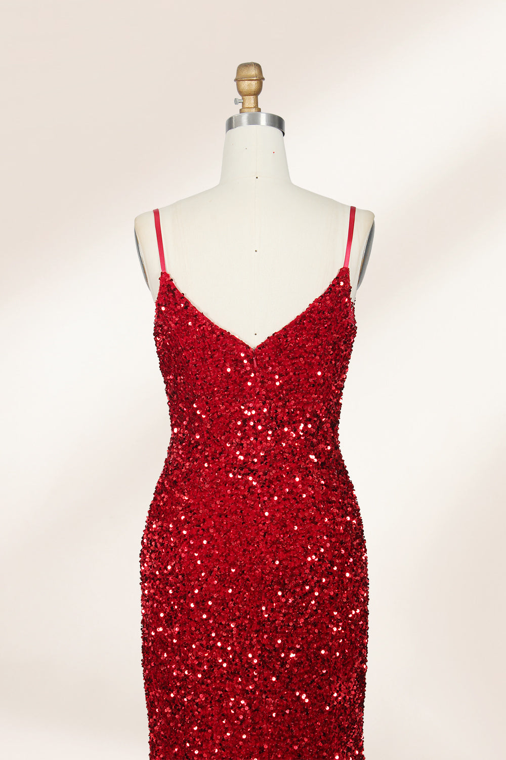 photograph of a mannequin wearing a red sequin evening gown, full-length, floor-length, sleeveless, V-neck, fitted bodice, flared skirt, glossy texture, elegant, glamorous, fashion, studio lighting, white background, soft shadows, high-end fashion, no accessories, no jewelry, no shoes, no face, no hair, no makeup, no background details, simple composition, focus on dress, no people, no textures, no patterns, no objects.06