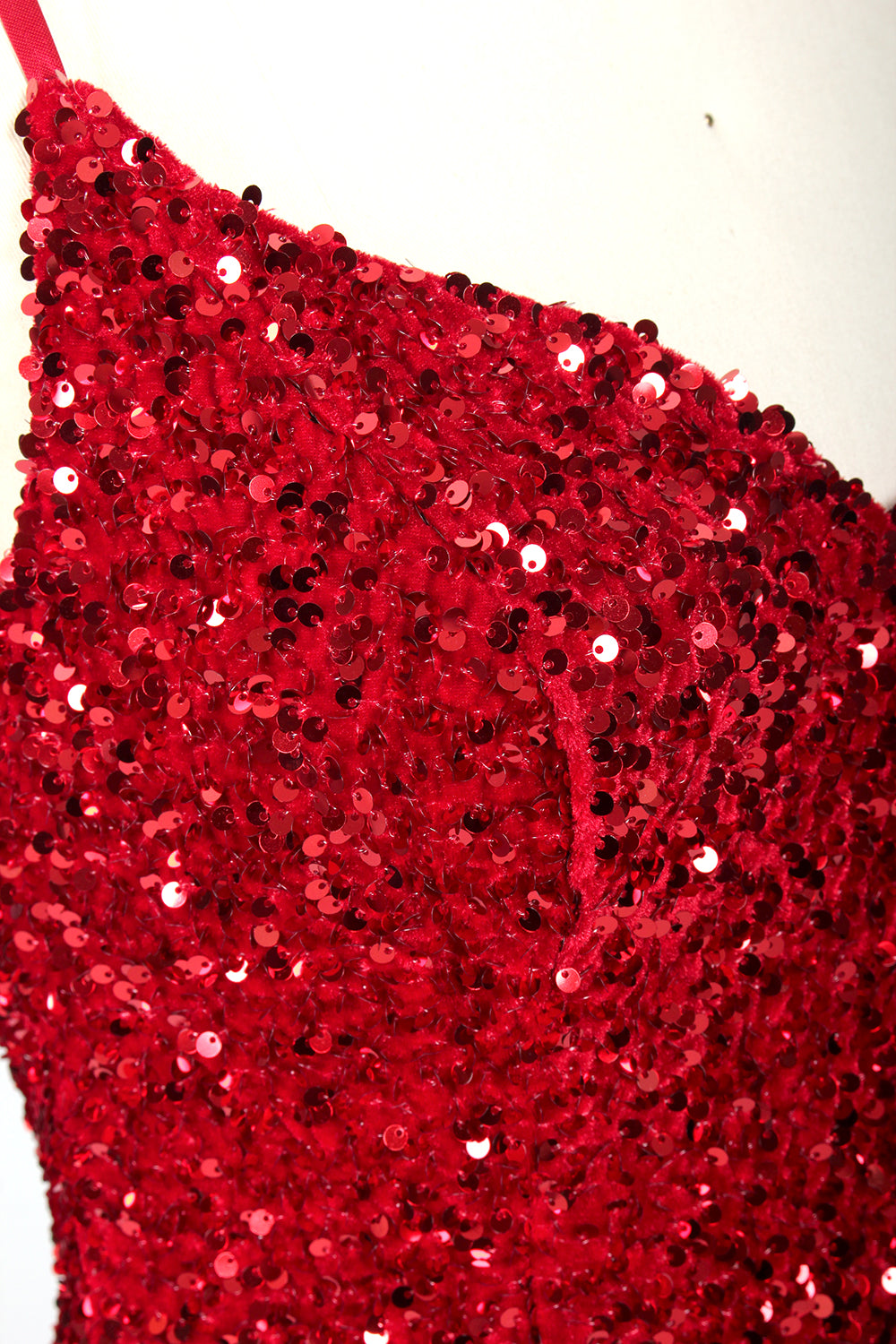 photograph of a mannequin wearing a red sequin evening gown, full-length, floor-length, sleeveless, V-neck, fitted bodice, flared skirt, glossy texture, elegant, glamorous, fashion, studio lighting, white background, soft shadows, high-end fashion, no accessories, no jewelry, no shoes, no face, no hair, no makeup, no background details, simple composition, focus on dress, no people, no textures, no patterns, no objects.05