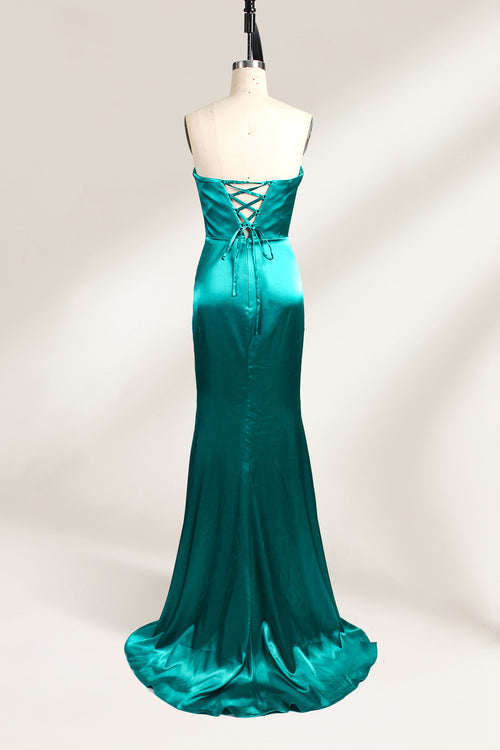 
A mannequin showcases a teal satin strapless gown. It has a ruched bodice, a fitted silhouette, and a flowing, floor - length skirt with a subtle train. The elegant design, featuring gathered details, makes it suitable for formal events like galas or weddings.2