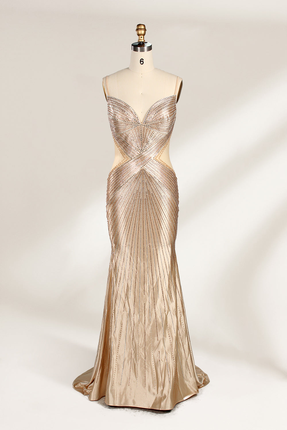 Set against a light backdrop, a mannequin presents a champagne - colored, beaded mermaid gown. It features a sweetheart neckline, cut - out sides, and intricate bead patterns radiating from the bodice. The shimmering beads and figure - hugging silhouette create a glamorous look, ideal for evening galas or proms.1