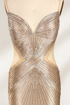 Set against a light backdrop, a mannequin presents a champagne - colored, beaded mermaid gown. It features a sweetheart neckline, cut - out sides, and intricate bead patterns radiating from the bodice. The shimmering beads and figure - hugging silhouette create a glamorous look, ideal for evening galas or proms.6