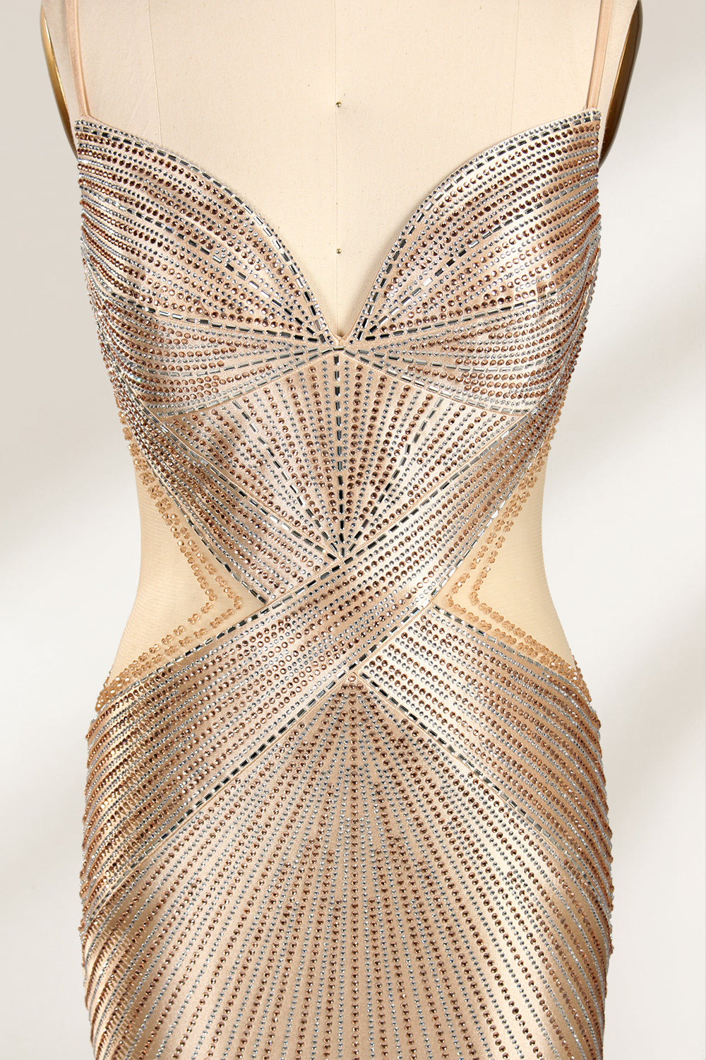 Set against a light backdrop, a mannequin presents a champagne - colored, beaded mermaid gown. It features a sweetheart neckline, cut - out sides, and intricate bead patterns radiating from the bodice. The shimmering beads and figure - hugging silhouette create a glamorous look, ideal for evening galas or proms.6