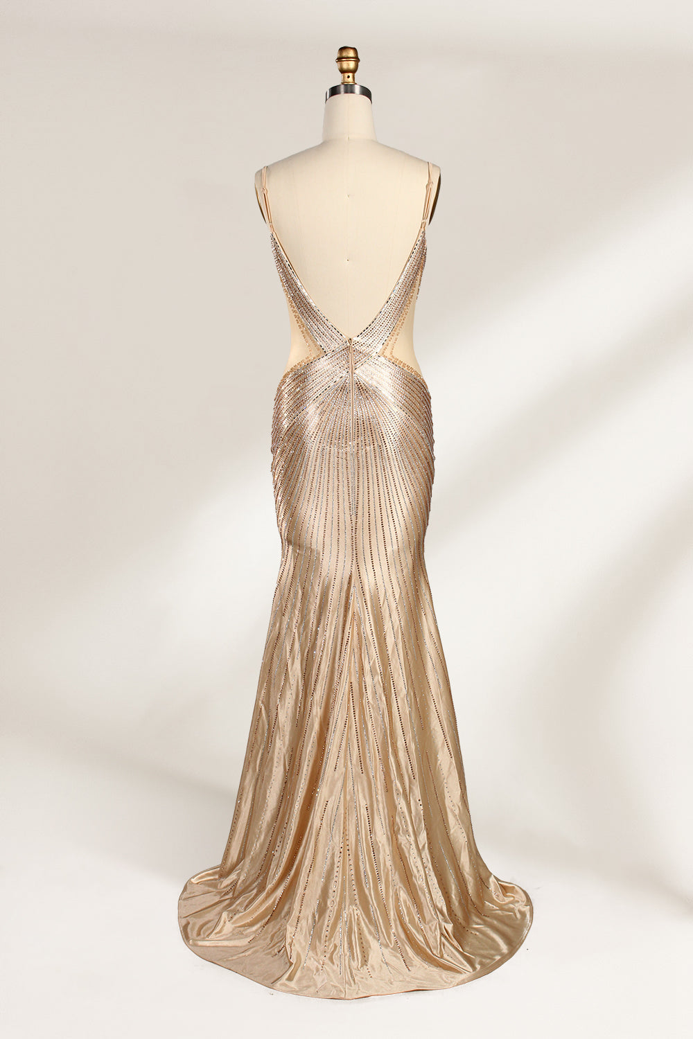 Set against a light backdrop, a mannequin presents a champagne - colored, beaded mermaid gown. It features a sweetheart neckline, cut - out sides, and intricate bead patterns radiating from the bodice. The shimmering beads and figure - hugging silhouette create a glamorous look, ideal for evening galas or proms.2