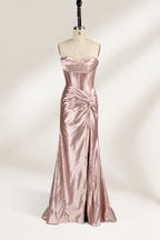 A mannequin showcases a strapless, blush - pink satin gown against a light backdrop. It features a ruched bodice with a draped neckline and a twisted detail at the waist, along with a mermaid silhouette and a side slit. The smooth satin fabric exudes elegance, perfect for formal events like galas.6