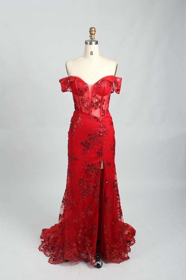 This photograph features a mannequin wearing an elegant, floor-length black lace gown. The gown has a sweetheart neckline, off-the-shoulder sleeves, and a high slit on one side, revealing a black thigh-high stocking. The intricate lace pattern is delicate and ornate, adding texture and visual interest. The mannequin stands against a plain, light beige background, emphasizing the dress's details. The number "2" is displayed on the mannequin's chest.08