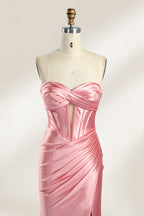 Against a gentle, light - colored backdrop, a mannequin showcases a strapless pink satin gown. The bust flaunts a twisted design, with a sheer insert at the bodice, and the waist is adorned with ruching. The mermaid - style skirt, featuring a high side slit, radiates elegance, perfect for formal galas.3