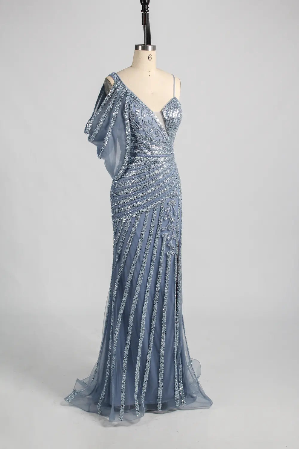 Blue asymmetric one-shoulder beaded gown with ruffled shoulder overlay