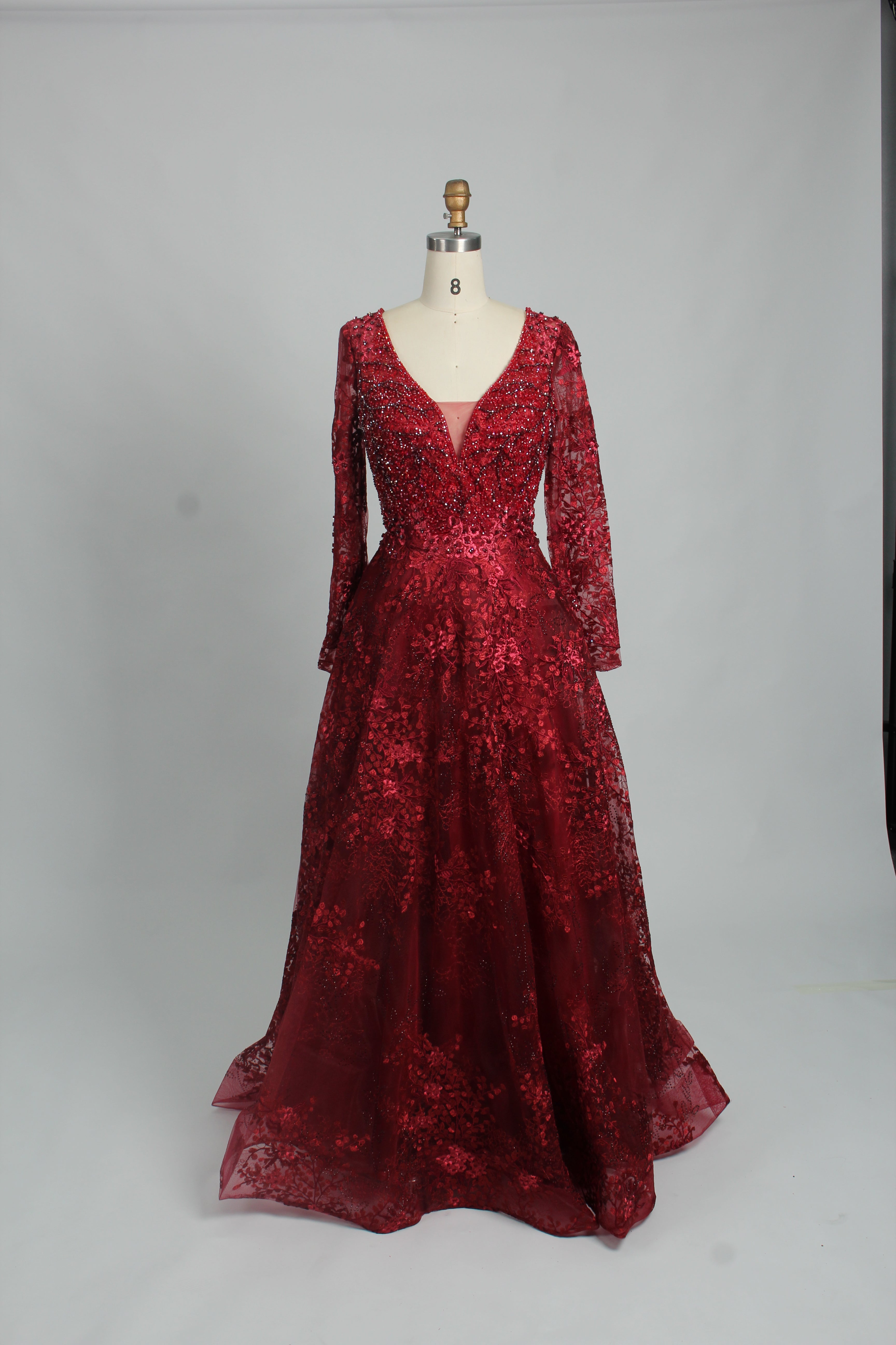 Red beaded tulle long-sleeve ball gown with plunging V-neck and flared hem